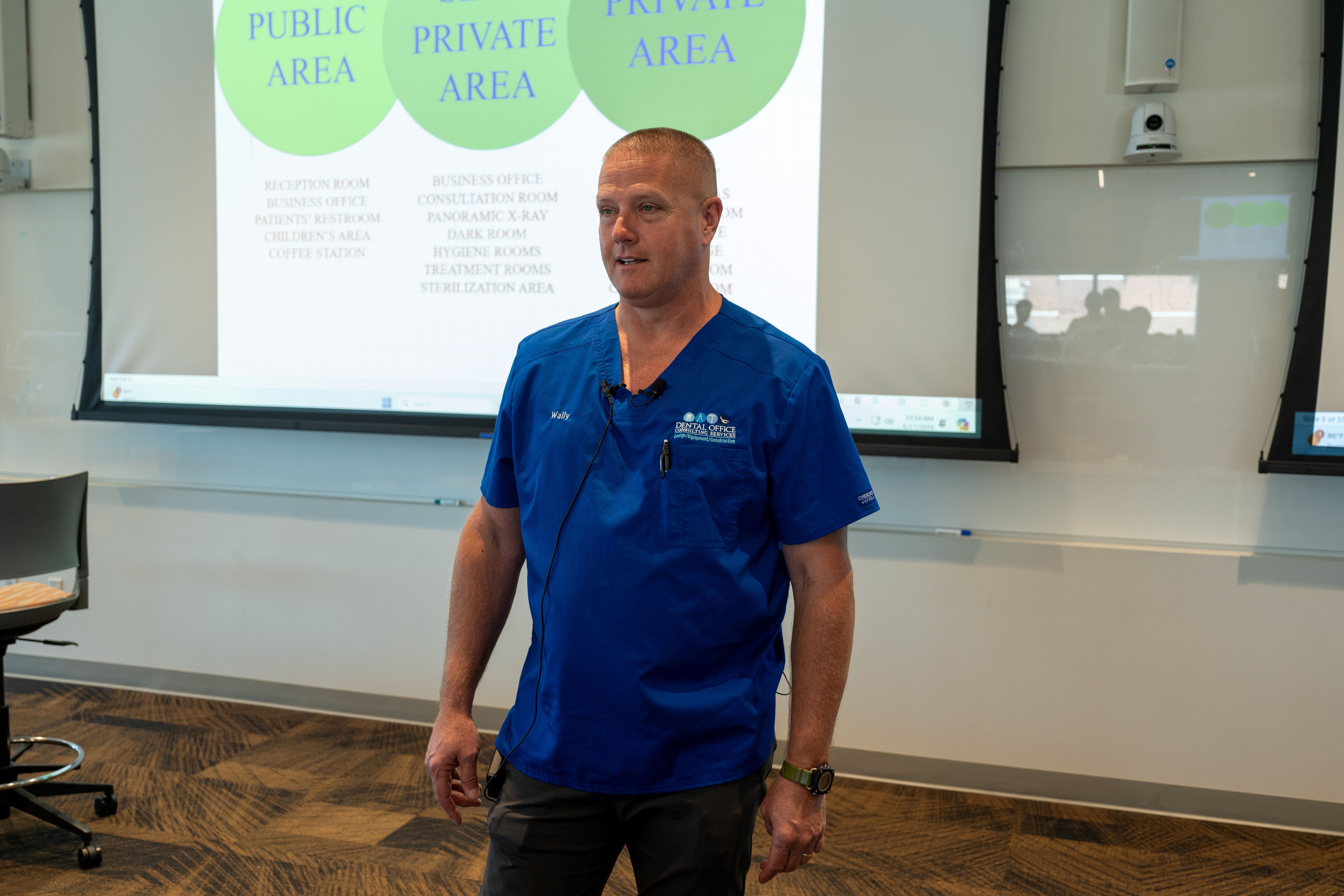 Wally presents his lecture on a large screen.
