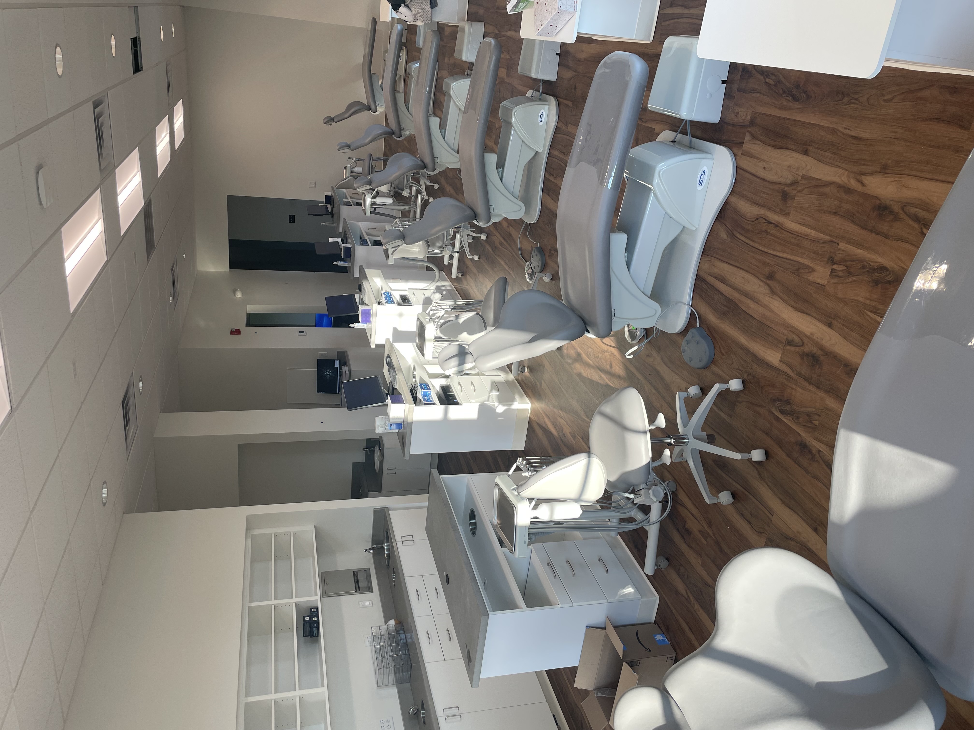 A dental office with many chairs.
